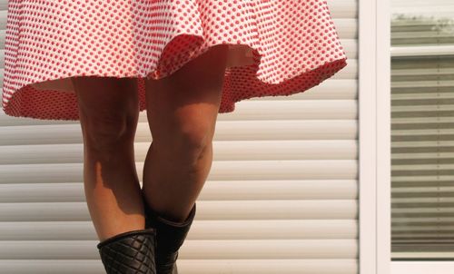 Low section of woman standing on tiled floor