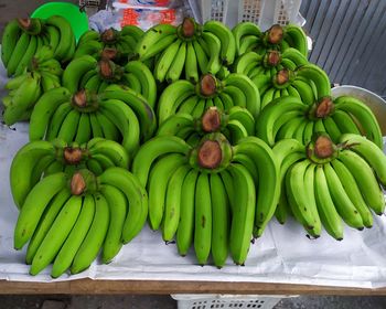 Green fruits for sale at market stall