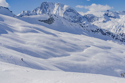 Scenic view of snow mountains against sky