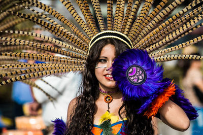 Smiling woman wearing traditional costume in city