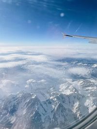 Aerial view of snowcapped mountains against sky