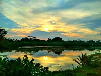 Scenic view of lake against sky during sunset