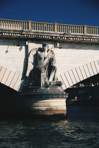 Statue of bridge against clear sky