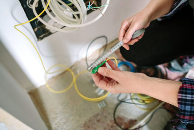 Telecommunications installer measuring fiber optic cable