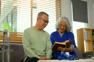 Friends using laptop at home