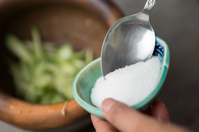 Close-up of hand holding bowl