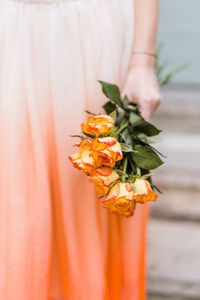 Cropped hand holding red flower