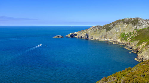 A motor boat moving across the sea close to holy island on anglesey, north wales, uk