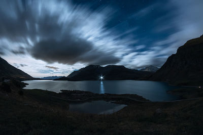 Scenic view of lake against sky at night