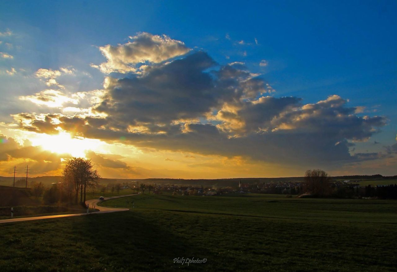 sunset, sky, cloud - sky, building exterior, scenics, beauty in nature, nature, built structure, sunlight, water, tranquil scene, tranquility, outdoors, sun, mountain, architecture, cloud, house, tree, silhouette