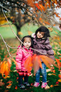 Portrait of smiling girl with plants during autumn