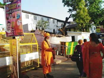 People in temple against sky in city