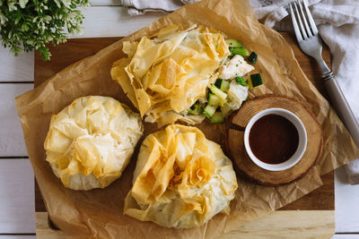 Phyllo purses. filo dough filled with chicken and vegetables. three baked filled veggie pastry bags.