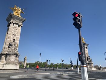 Low angle view of road signal against sky