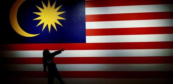 Woman standing by malaysian flag