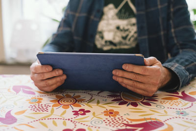 Midsection of man using mobile phone