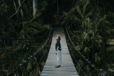 Man walking on footpath in forest