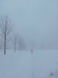 Scenic view of snow covered field against sky