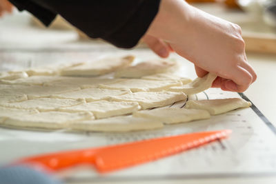 Cropped hand of person preparing food