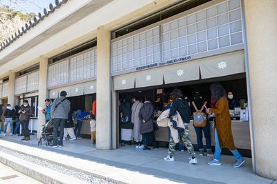 Group of people walking in front of building