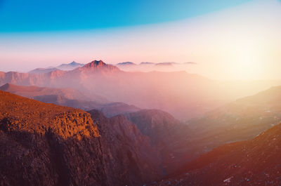 Scenic view of mountains against sky during sunset