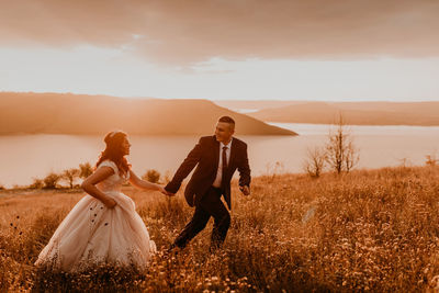 Rear view of couple standing on field