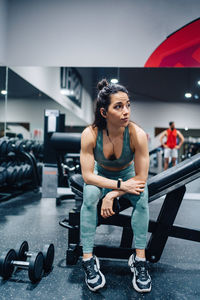 Side view of woman exercising in gym