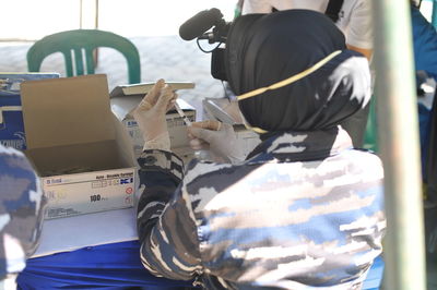 Rear view of man sitting on bus