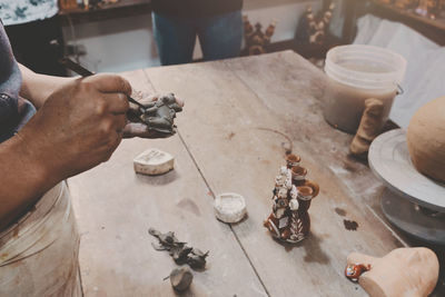 Cropped hand of man working on table