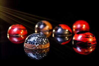 Close-up of balls on table against black background