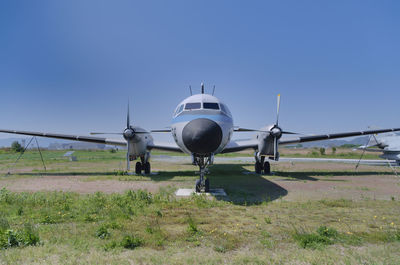 Airplane on field against clear sky