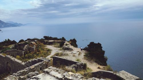 High angle view of sea and mountains against sky