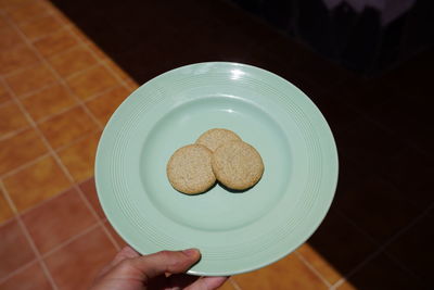 High angle view of hand holding cookies