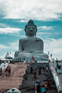 Statue of temple against cloudy sky