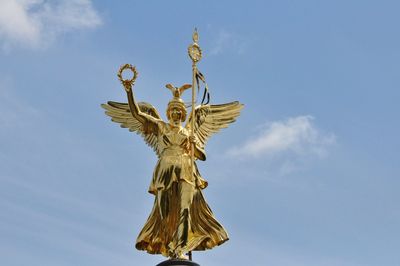 Low angle view of statue against blue sky