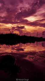 Scenic view of lake against romantic sky at sunset