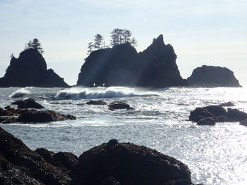 Rock formation in sea against sky