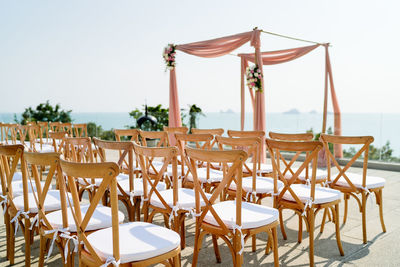 Close-up of chairs on table against clear sky
