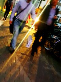 Low section of people walking on road