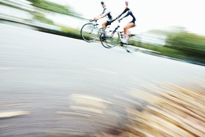 People riding bicycle on street in city