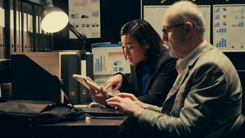Side view of business colleagues working at office