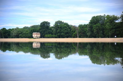 Reflection of trees in lake against sky