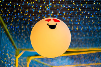 Close-up of balloons with ball and swimming pool