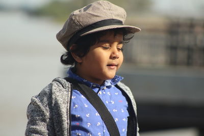 Boy with eyes closed standing at beach