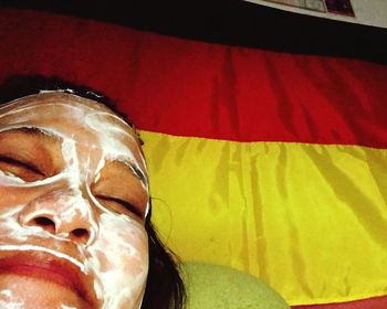 Close-up of red relaxing on bed