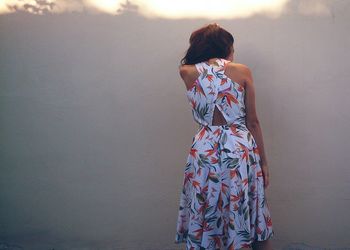 Rear view of woman standing against sky
