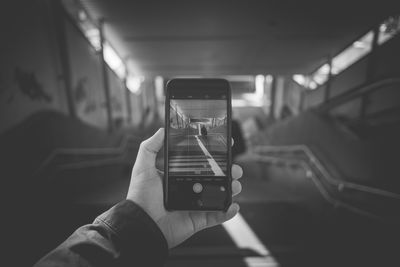 Close-up of man photographing through smart phone