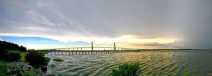 Panoramic view of bridge over sea against sky