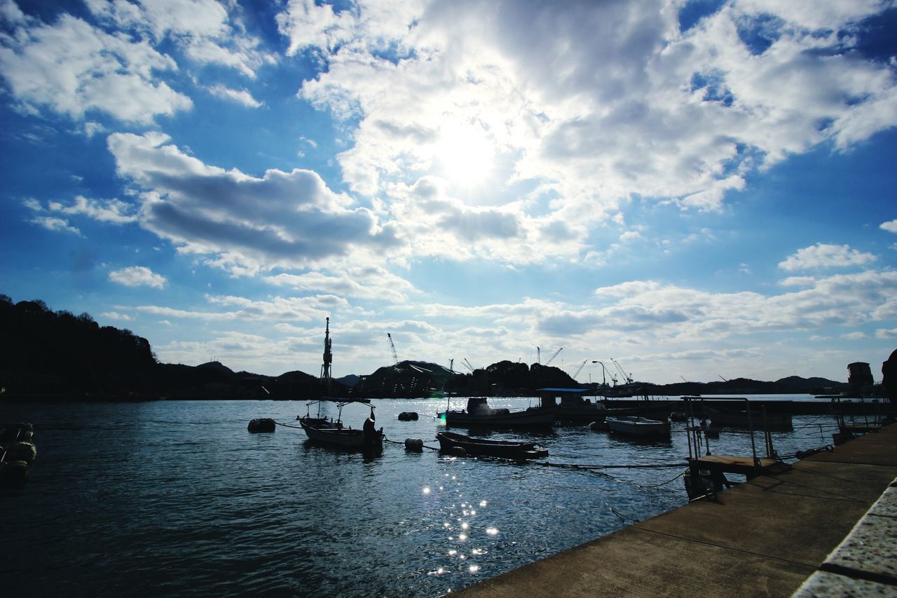 water, sky, nautical vessel, cloud - sky, built structure, transportation, river, architecture, harbor, mode of transport, building exterior, boat, cloud, waterfront, moored, cloudy, nature, city, silhouette, outdoors