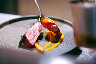 Close-up of orange slice in plate on table